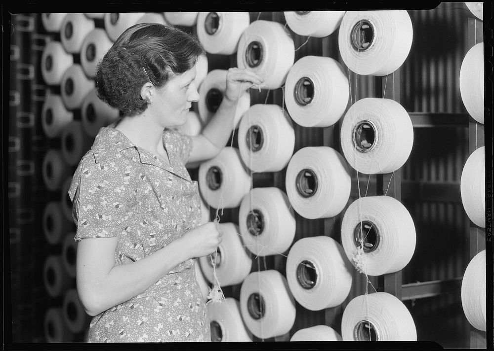 Woman standing at large spools of thread, 1936. Photographer: Hine, Lewis. Original public domain image from Flickr