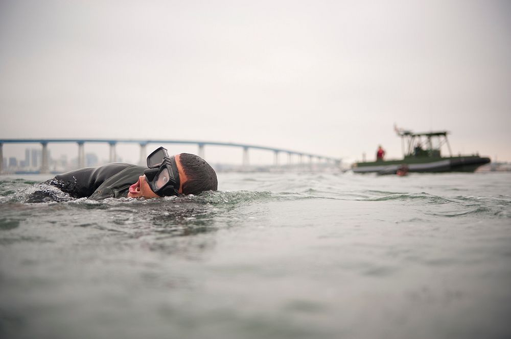 A U.S. Navy Basic Underwater Demolition/SEAL (BUD/S) student participates in interval swim training in San Diego Bay Aug. 2…