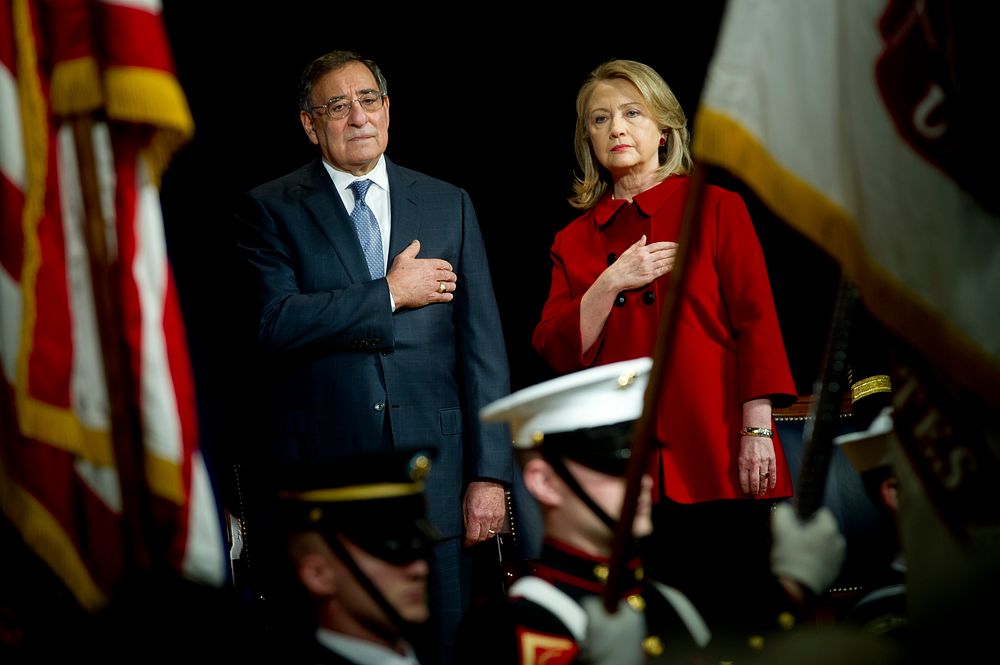 Secretary of Defense Leon E. Panetta, left, and former Secretary of State Hillary Clinton put their hands over their hearts…