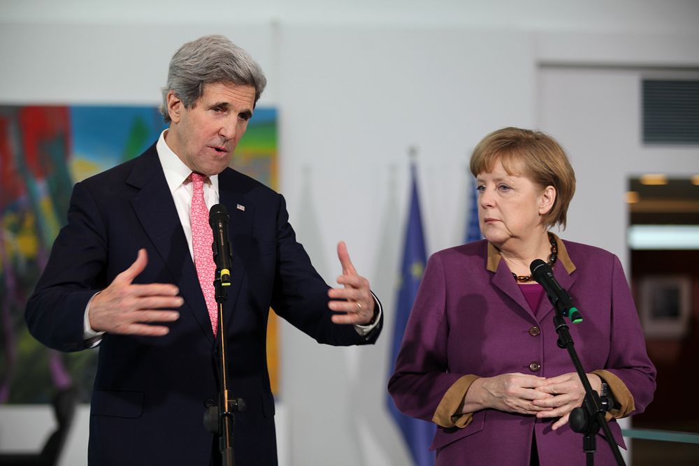 Secretary of State Kerry addresses the media with German Chancellor Merkel. Original public domain image from Flickr
