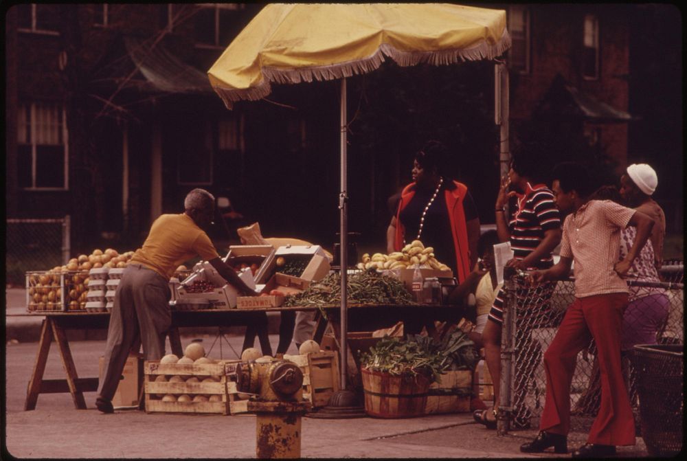 Black Sidewalk Salesmen Arranging Their Fresh Fruits And Vegetables On Chicago's South Side, 06/1973. Photographer: White…