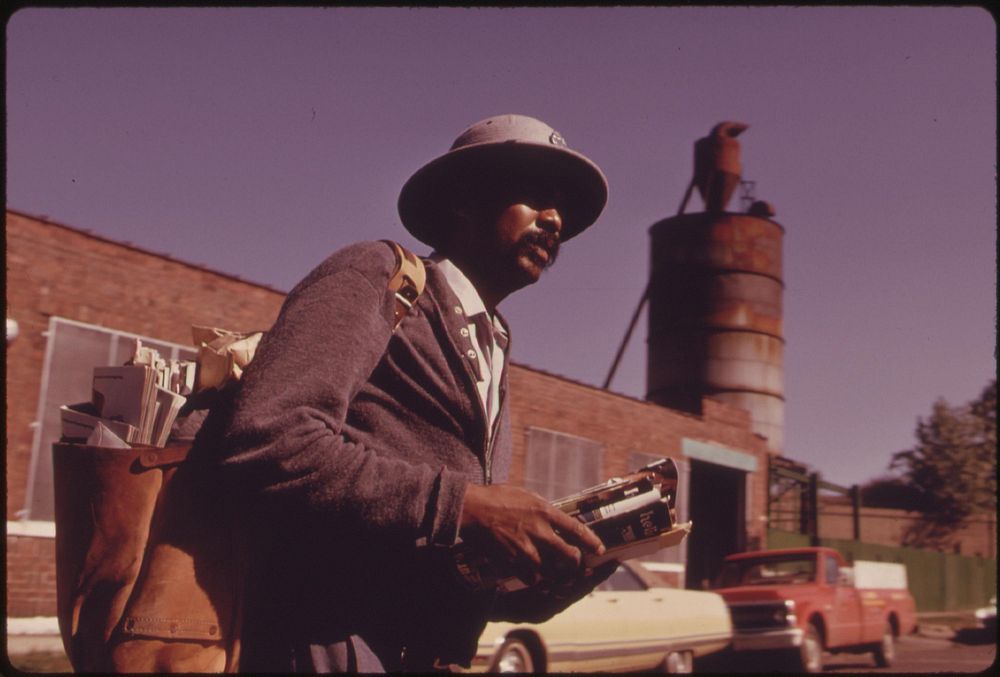 A Black Man Delivers Mail To The Block Of East 43rd Street On Chicago's South Side, 10/1973. Photographer: White, John H.…