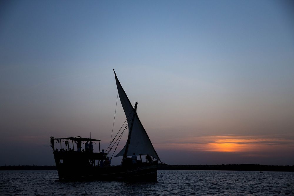The sun sets as a traditional dhow cruise run by Turtle Bay Resort sails along Mida Creek near the Indian Ocean coastal…