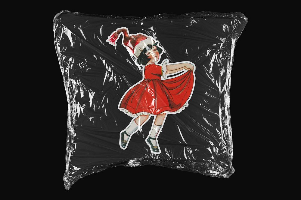 Dancing little girl, Christmas plastic wrap isolated on black design. Remixed by rawpixel.