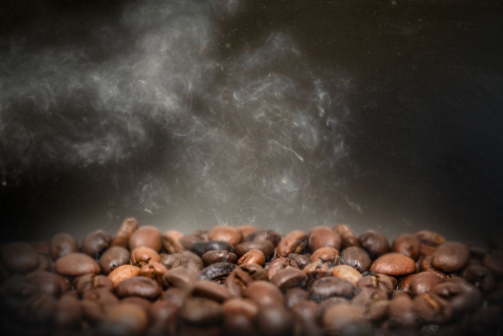 Roasted coffee beans, dark image with copy space