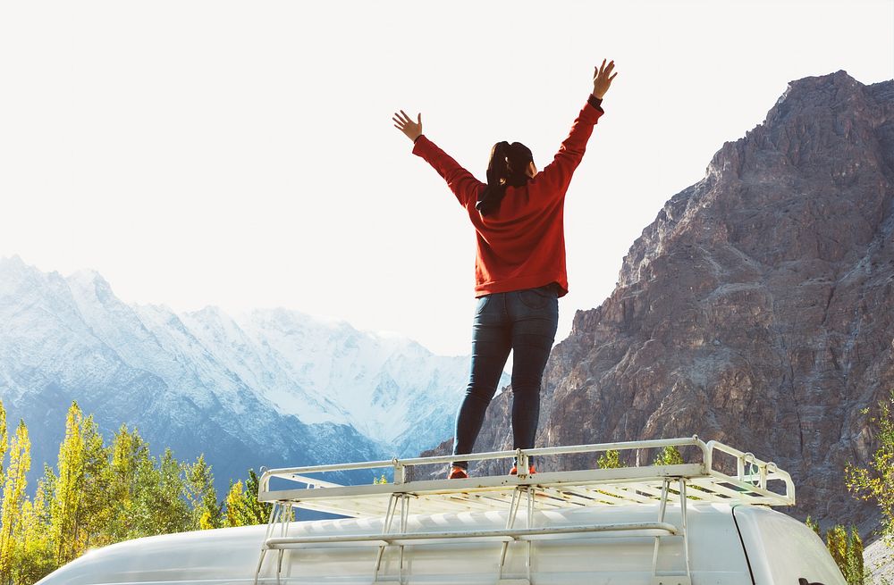 Woman standing on a van facing the beautiful mountain image element 