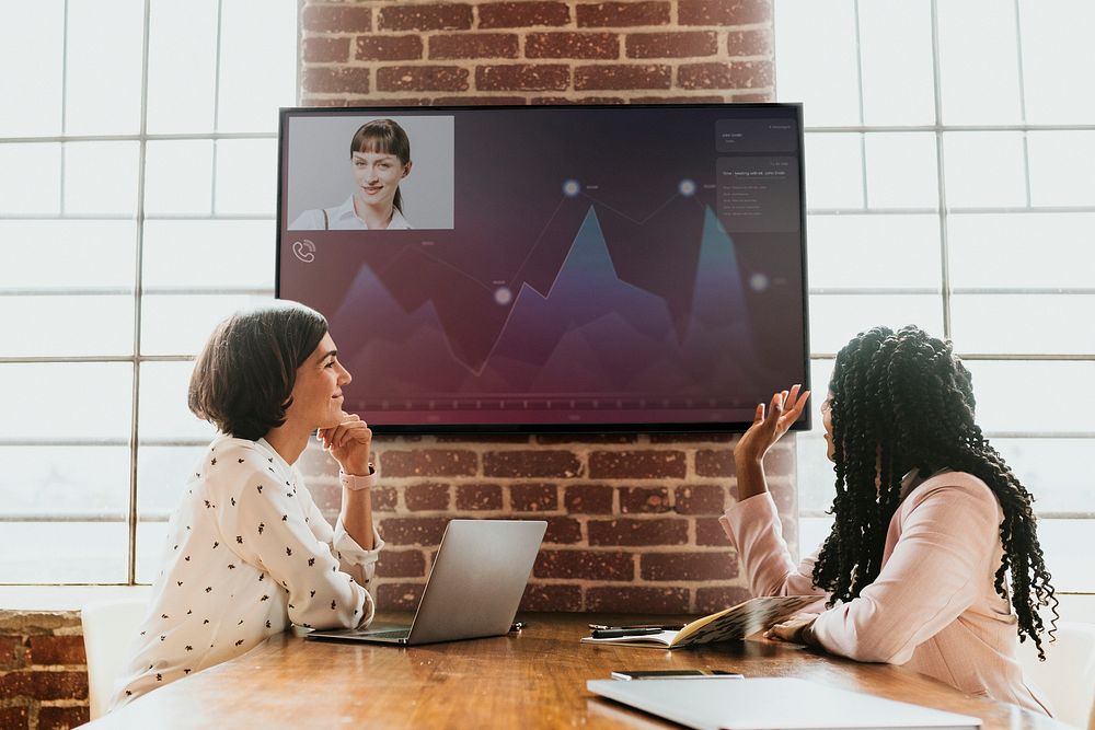 Diverse colleagues having a conference with a tv screen mockup