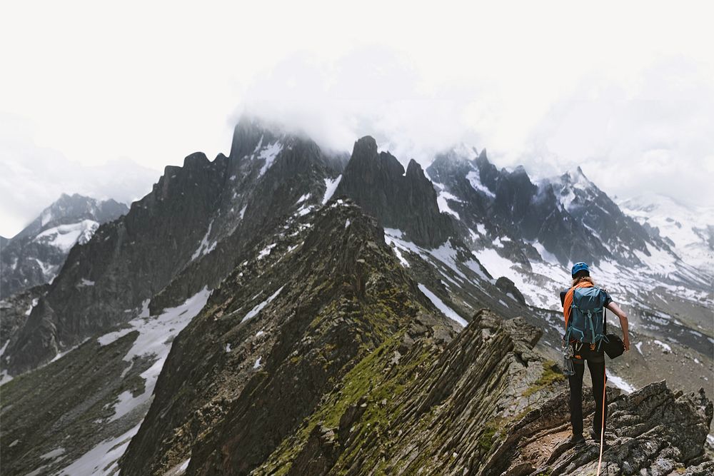 Backpacker hiking up Chamonix Alps in France border background