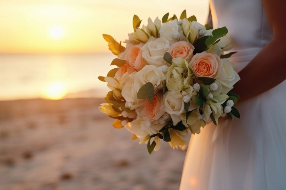 Closeup groom and bride have bouquet at the sunset beach, focus on bouquet. AI generated Image by rawpixel. 