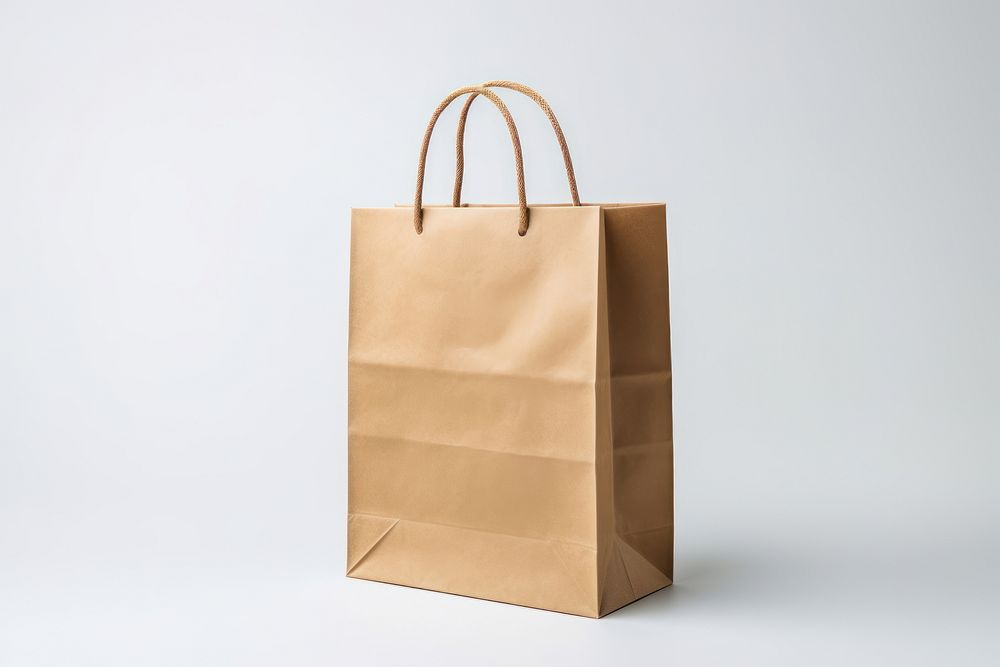 Craft-paper bag handbag white background studio shot. AI generated Image by rawpixel.