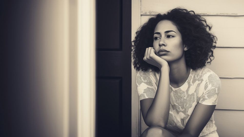 Authentic photo of mixed race woman is sitting and contemplating something. AI generated Image by rawpixel. 