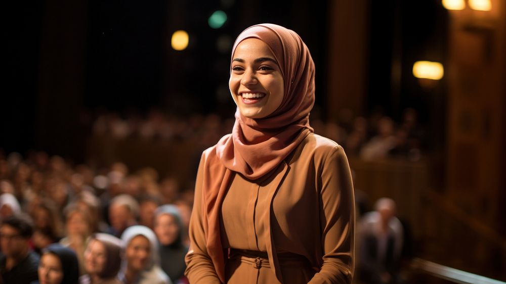 Young Muslim woman speaker on professional stage.  