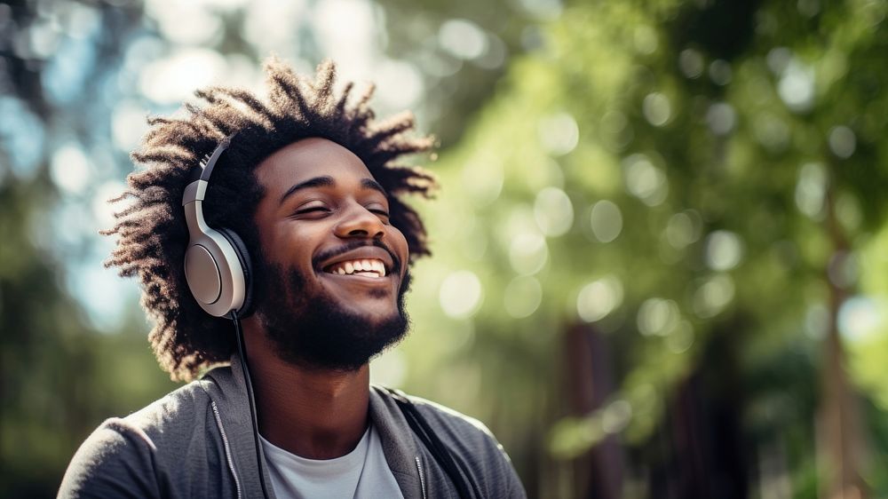 Happy man headphones listening outdoors.  