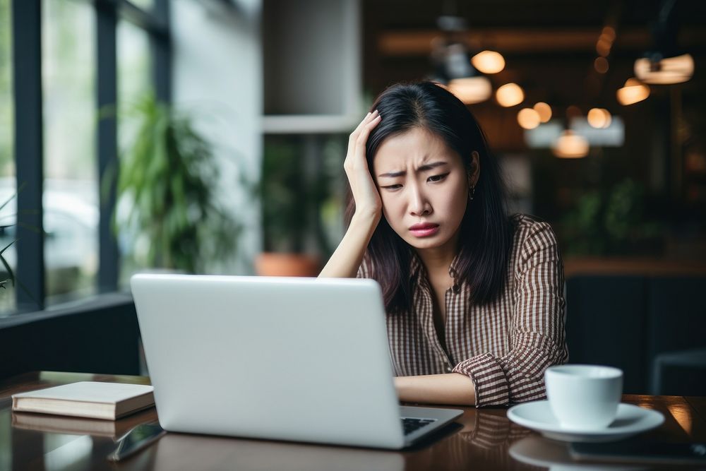 Woman working laptop computer worried. AI generated Image by rawpixel.