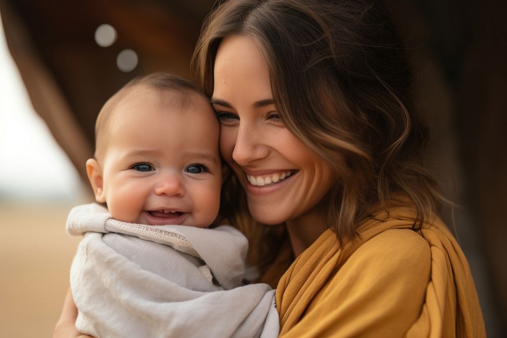 Woman holding adorable baby laughing portrait female. 