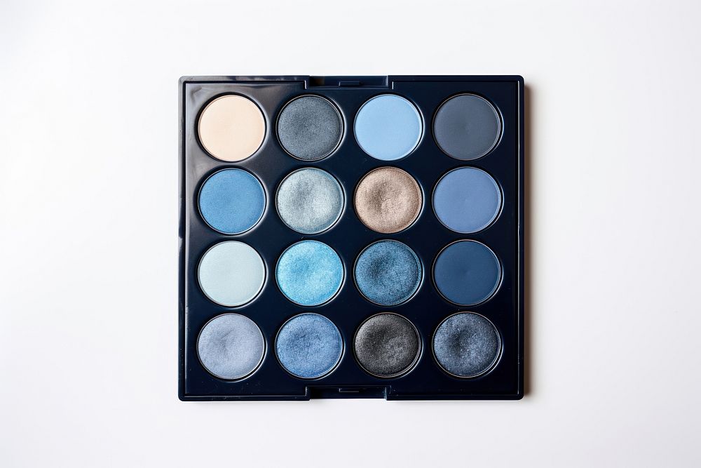 Blue eyeshadow palette cosmetics white background arrangement. 