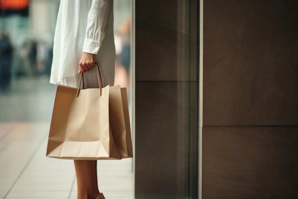 Woman holding shopping bags handbag architecture consumerism. 