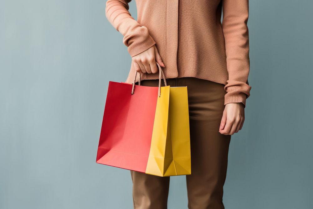 Woman holding a paper shopping bag handbag adult woman. AI generated Image by rawpixel.