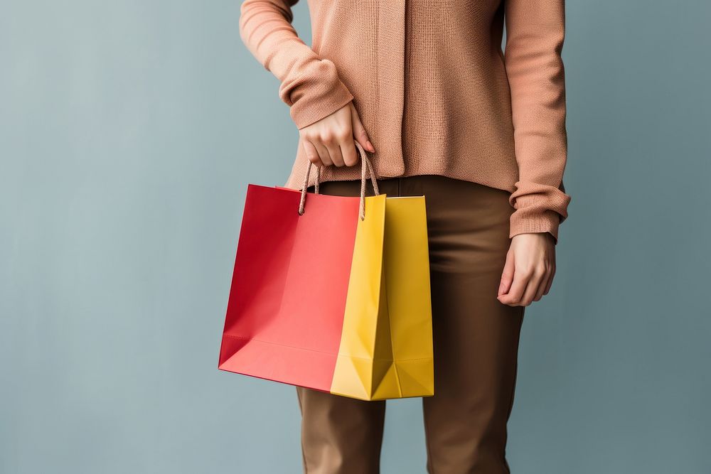 Woman holding a paper shopping bag handbag adult woman. 