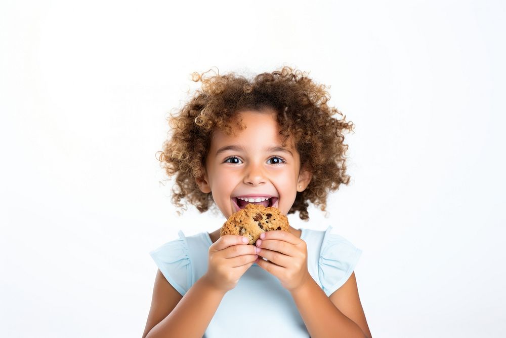 A girl eating cookies dessert biting child. 