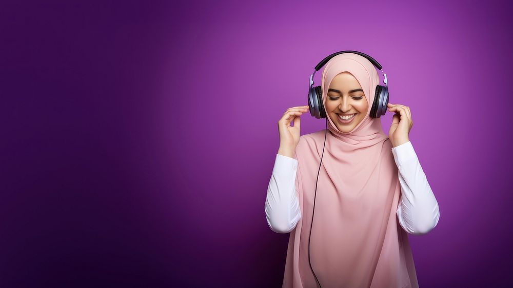 photo of a muslim woman wearing headphones. AI generated Image by rawpixel. 