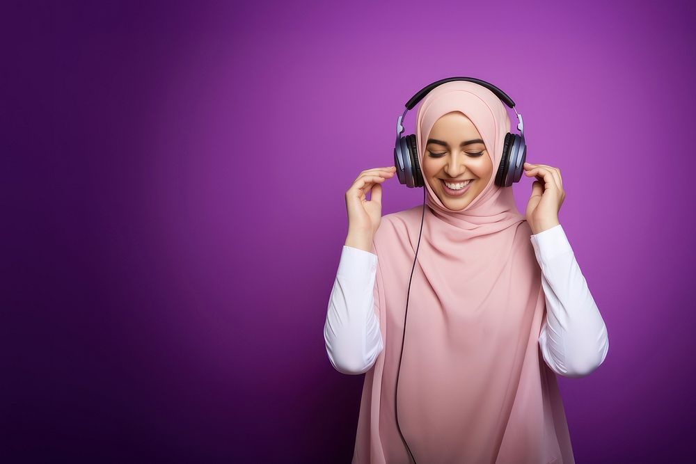 photo of a muslim woman wearing headphones. AI generated Image by rawpixel. 