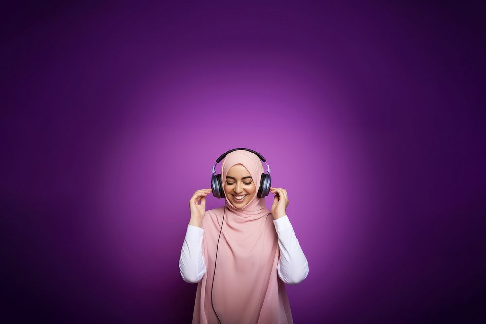 photo of a muslim woman wearing headphones.  