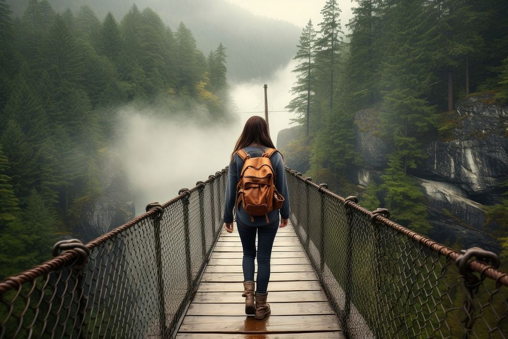 Woman hiking walking across bridge adventure outdoors backpack. AI generated Image by rawpixel.