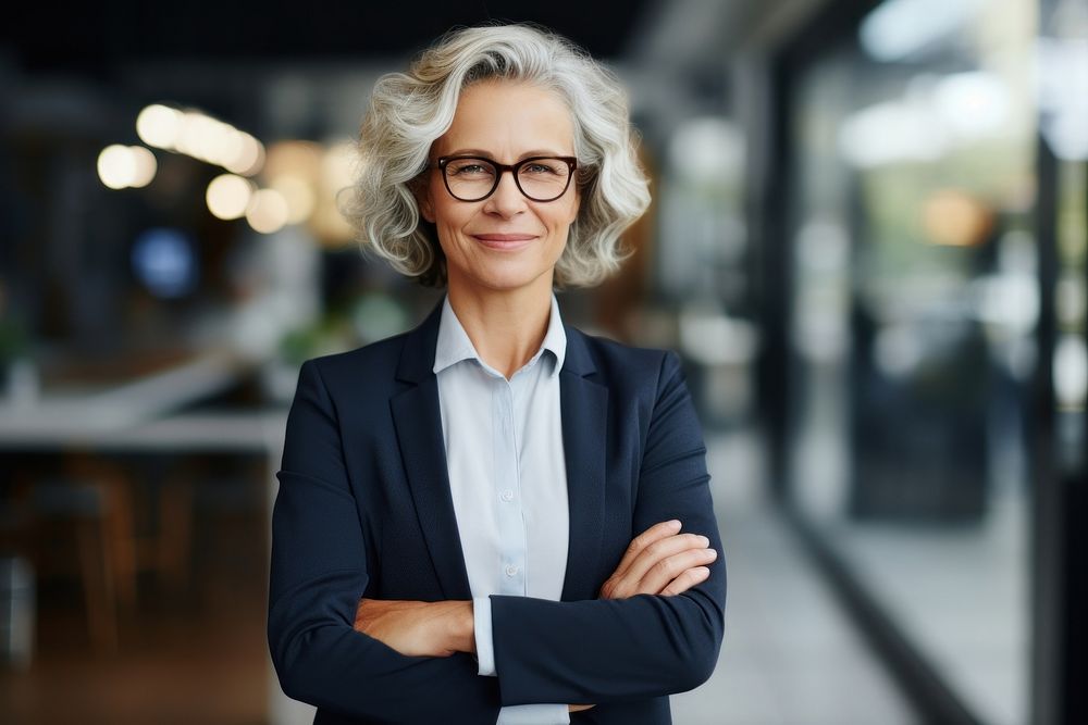 Middle aged business woman smiling arms crossed glasses adult entrepreneur. AI generated Image by rawpixel.