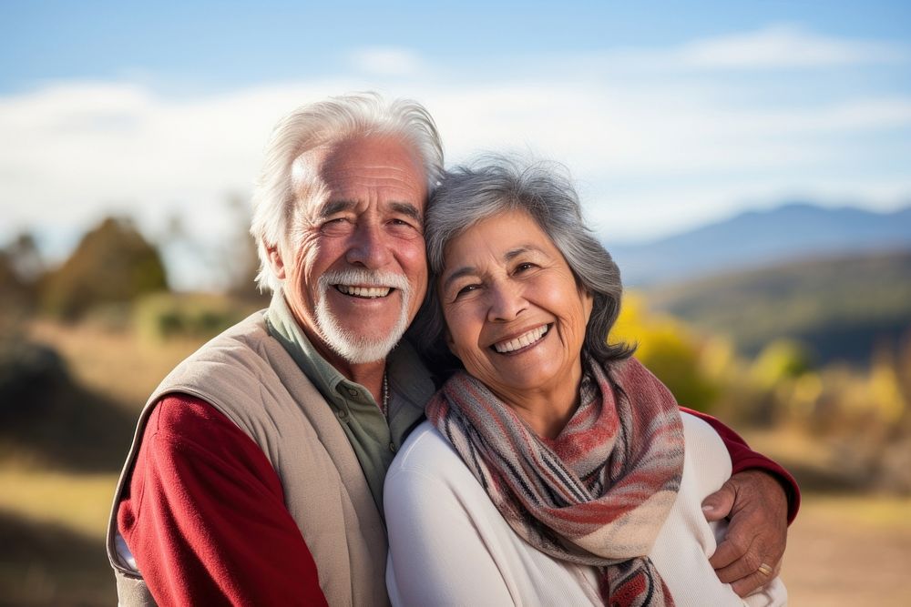 Elderly Hispanic couple retirement laughing outdoors. 