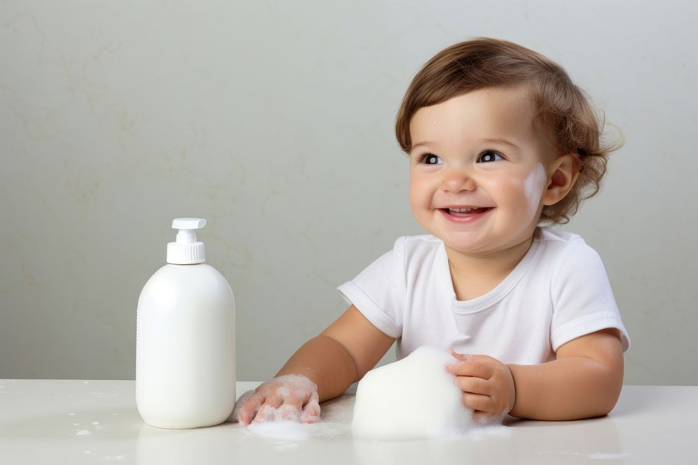 Baby bottle shampoo portrait bathroom sitting. AI generated Image by rawpixel.