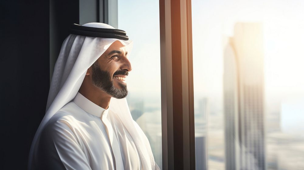 Photo of an Arabic businessman looking out of a window. 