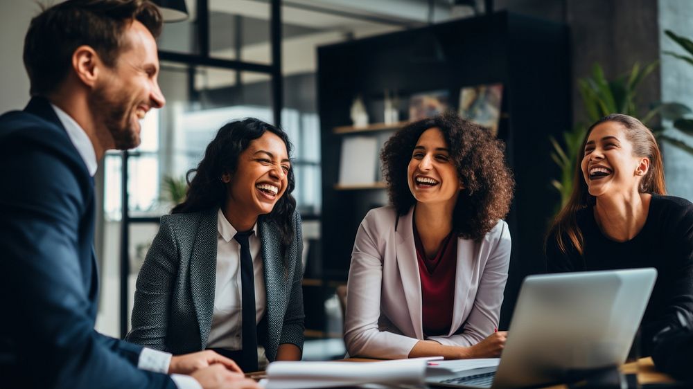 Photo of office workers laughing in the meeting room. 