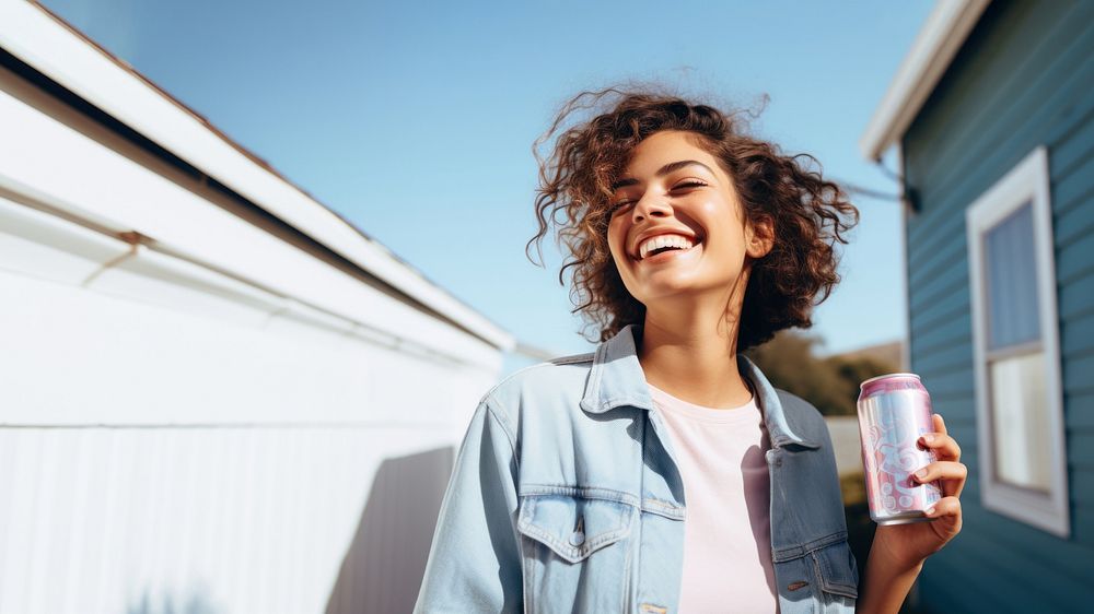 Portrait photo of a happy woman holding aluminum can looking at out side on minimal home. 