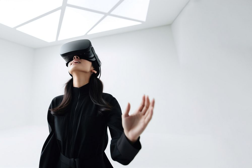 South-East asian girl playing VR game wearing all black outfit. AI generated Image by rawpixel.