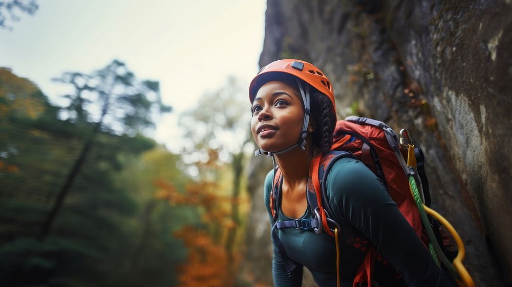 Photo of a african american female hiker go rock climbing. 