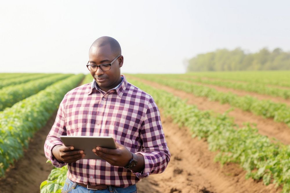 Photo of Black American farmer with digital tablet in potato field. AI generated Image by rawpixel.