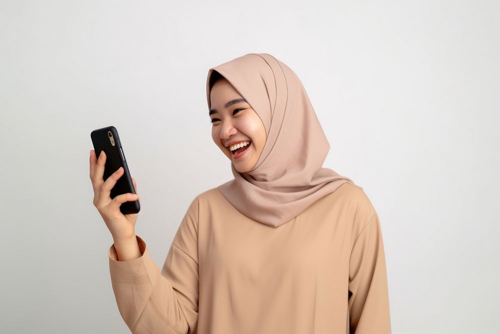 Happy Asian Muslim adult photo phone. AI generated Image by rawpixel.