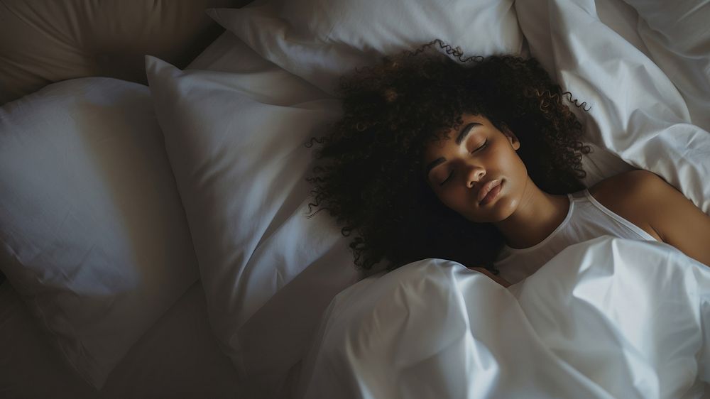 photos of a black woman lying on the side sleeping in white bed. AI generated Image by rawpixel.