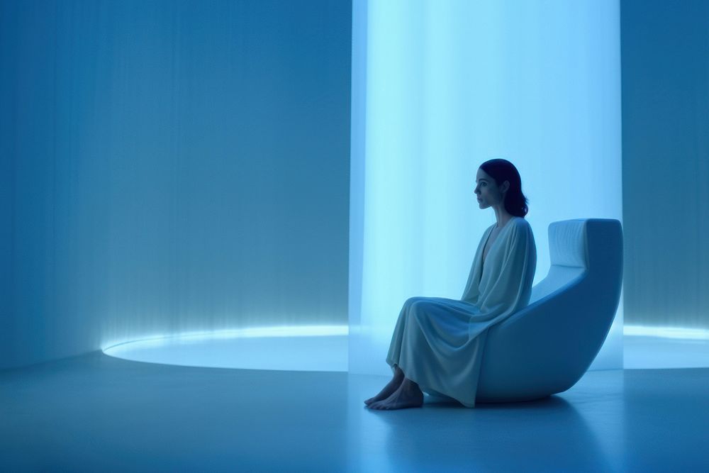 Woman sitting in a white room. 