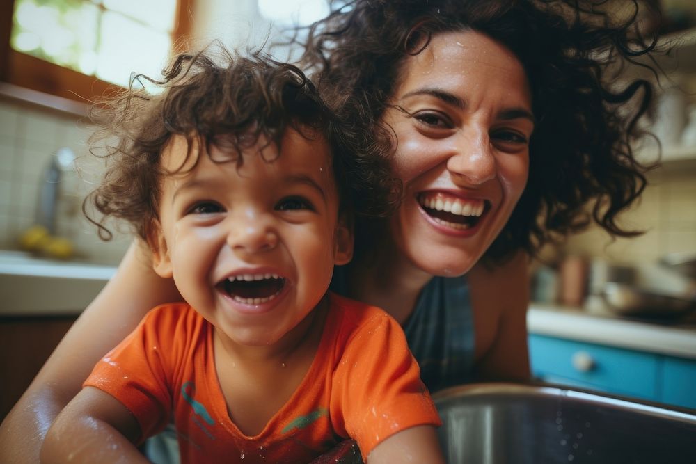 Mother child laughing in kitchen. .