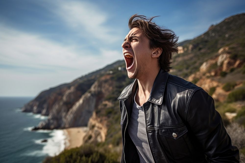 Young adult shouting cliff sea. 