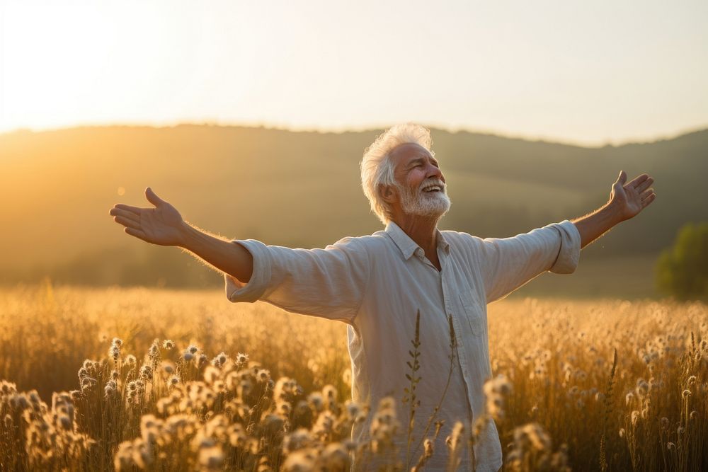 Joyful old man sunlight summer field. 