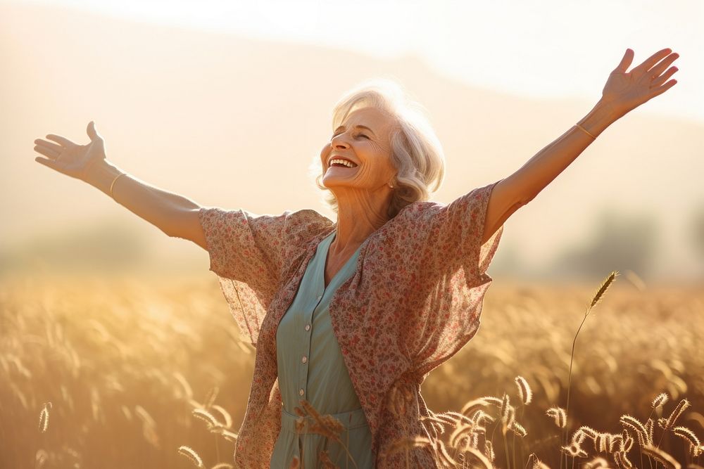 Joyful old woman sunlight summer field. 