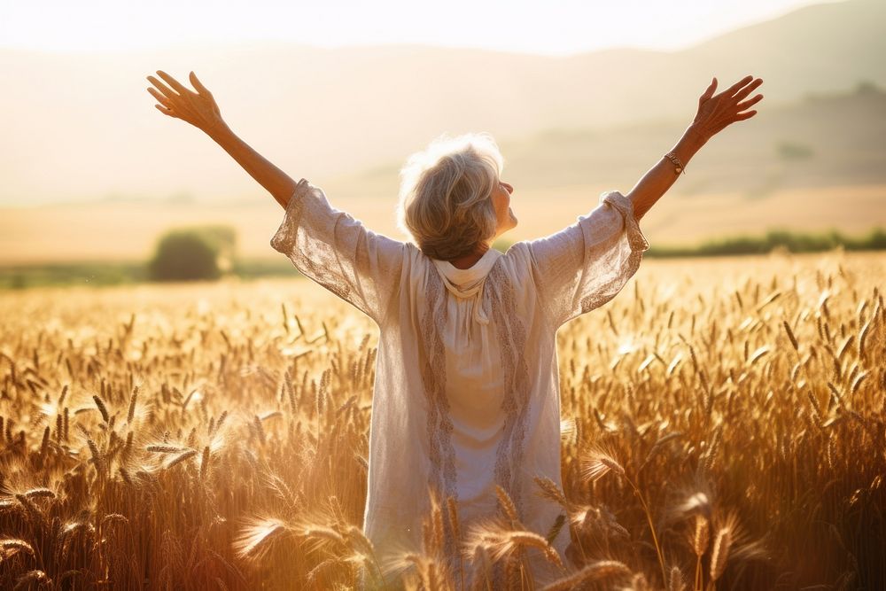 Joyful old woman sunlight summer field. 