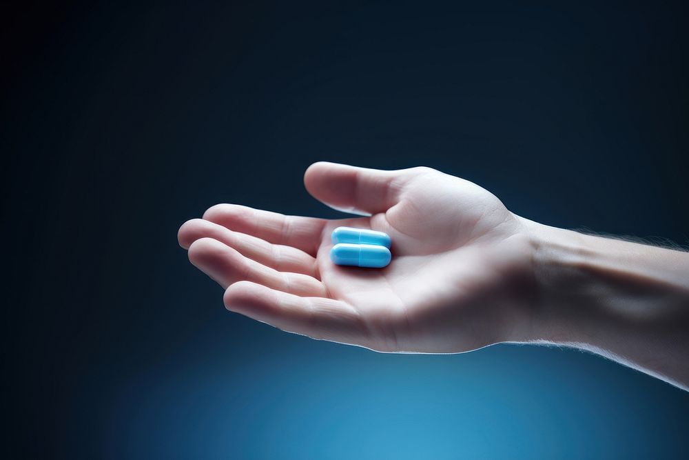Pill hand photo blue. AI generated Image by rawpixel.