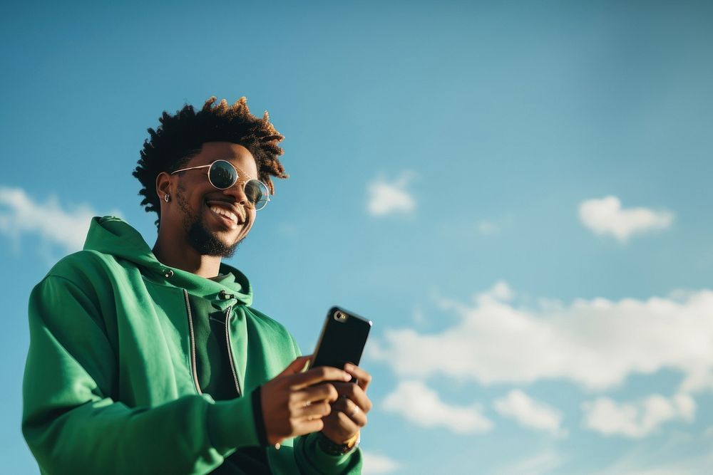 photo of black man wearing green tone outfit using smartphone. AI generated Image by rawpixel.
