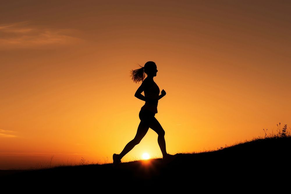 photo of silhouette woman run on the hill with sunset. 