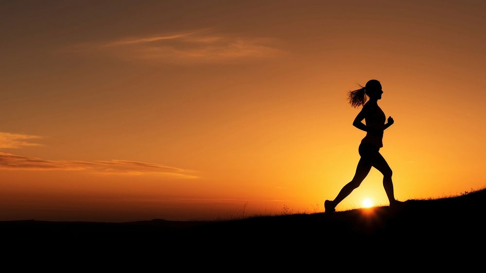 photo of silhouette woman run on the hill with sunset. 