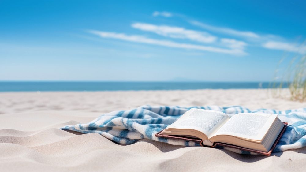 Book on the picnic blanket in beach white sand. AI generated Image by rawpixel. 